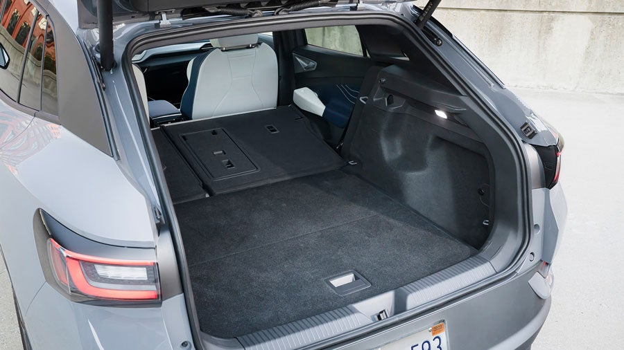 Image of a Pure Gray ID.4 showing off its cargo space with the second row folded down.
